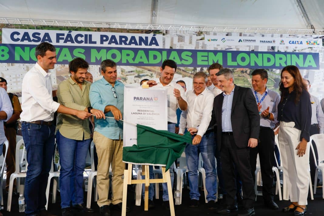 Autoridades com a placa de inauguração de um condomínio